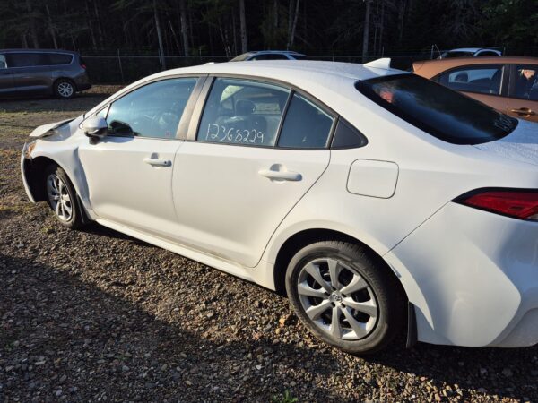 damaged-white-toyota-corolla-rear-side-profile-view