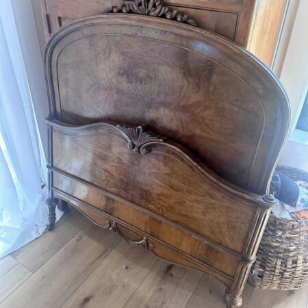 View of vintage full-sized wooden bed – classic design