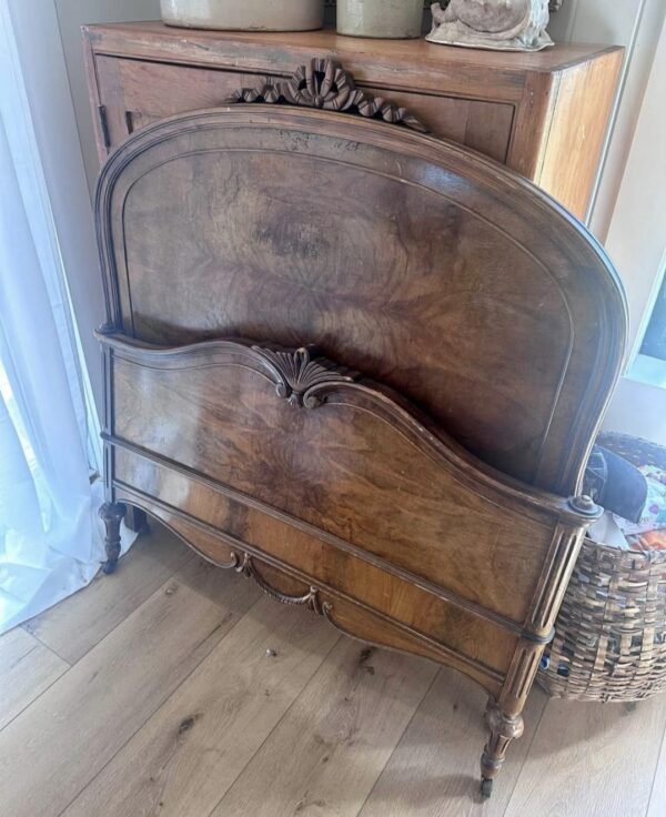 View of vintage full-sized wooden bed – classic design