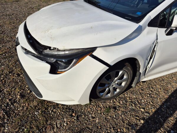 white-toyota-corolla-driver-side-impact-damage